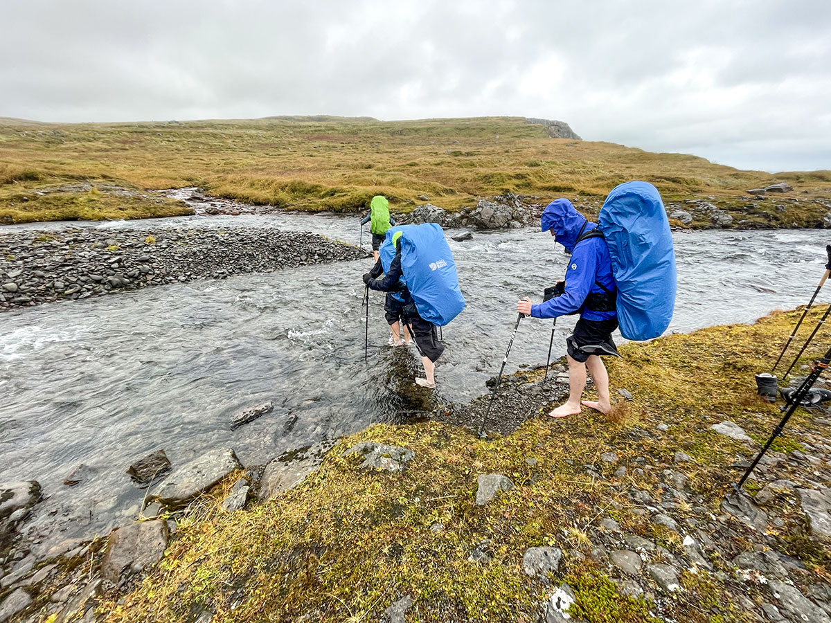 Crossing a river with hiking poles